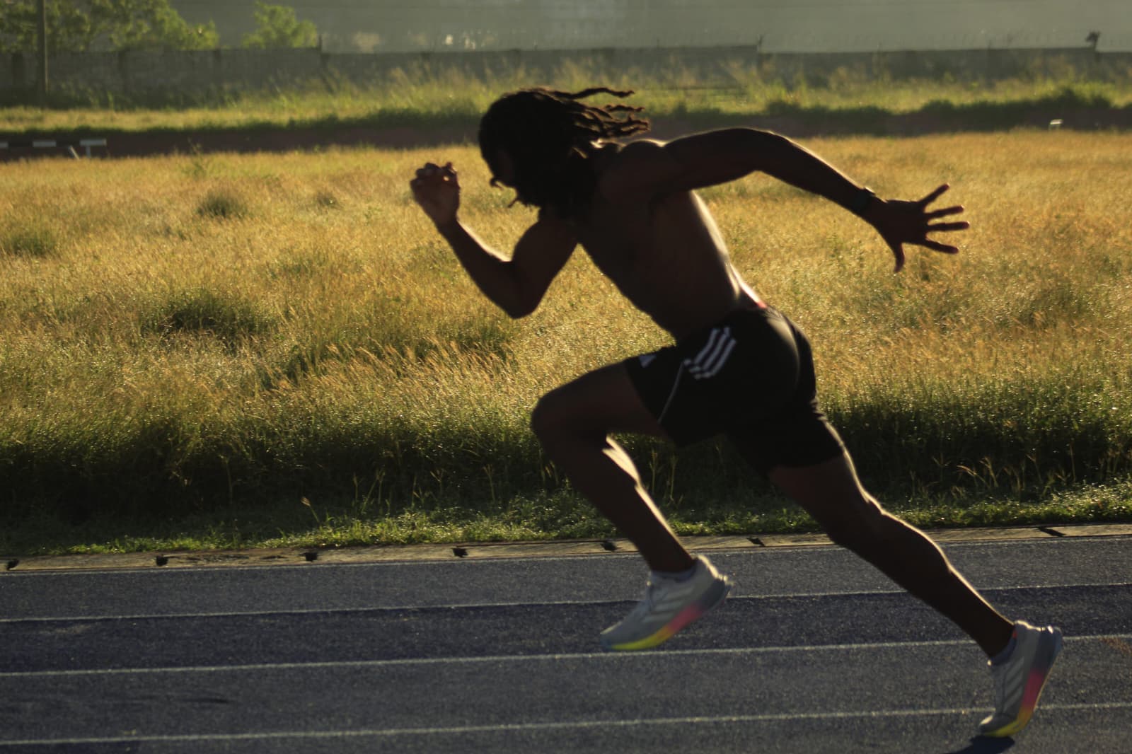 Athlete sprinting at golden hour